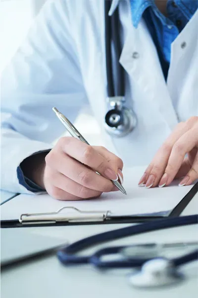 Advanced-Diagnostic-Testing-Treatment A doctor takes notes. Get Preventative Diagnostic care from Jennifer Jose-Cappola, MD in Stamford.