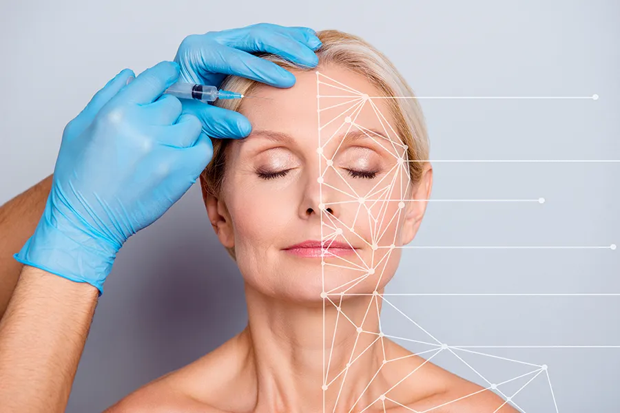 Aesthetic-Injectables-Clinic A mature blonde woman gets a facial injection. Get injectable aesthetic treatments from Jennifer Jose-Cappola, MD in Stamford.