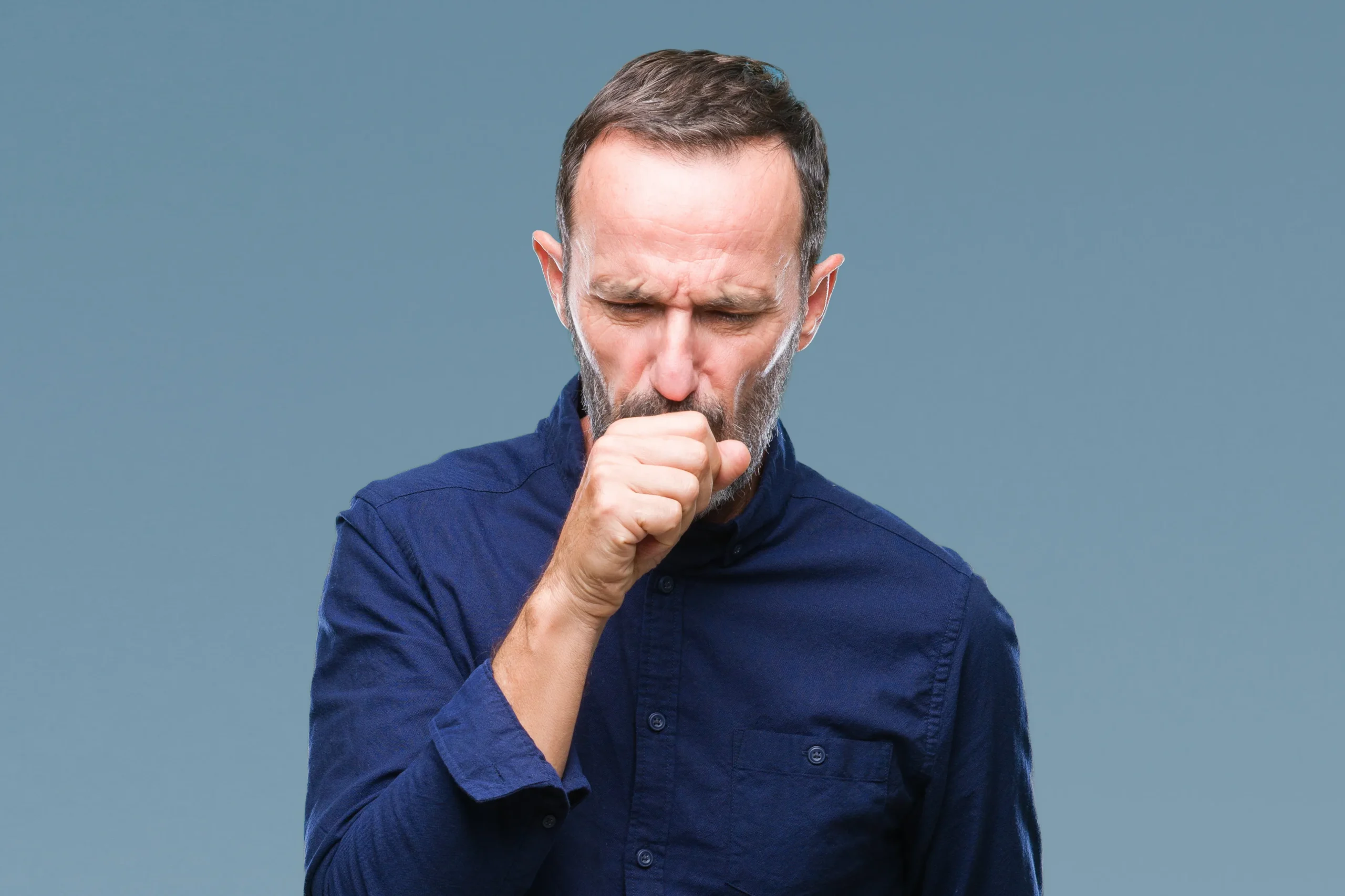 Chronic-Disease-Clinic A middle-aged man coughs into his hand. Schedule Chronic Disease treatment from Jennifer Jose-Cappola, MD in Stamford.