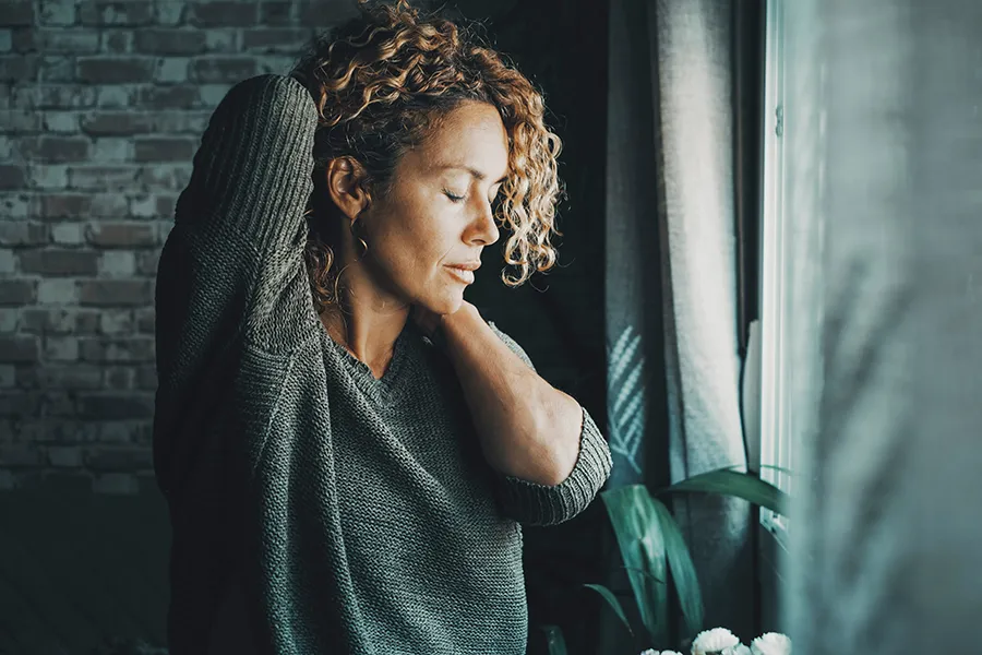 Cryotherapy-for-Pain-Clinic A woman holds her head and neck in pain. Get Cryotherapy for pain relief from Jennifer Jose-Cappola, MD in Stamford.