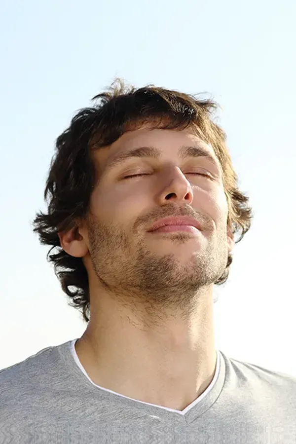 Depression-Treatment A man with closed eyes and a smile turns his head to the sky calmly. Get treatment for depression from Jennifer Jose-Cappola, MD in Stamford.