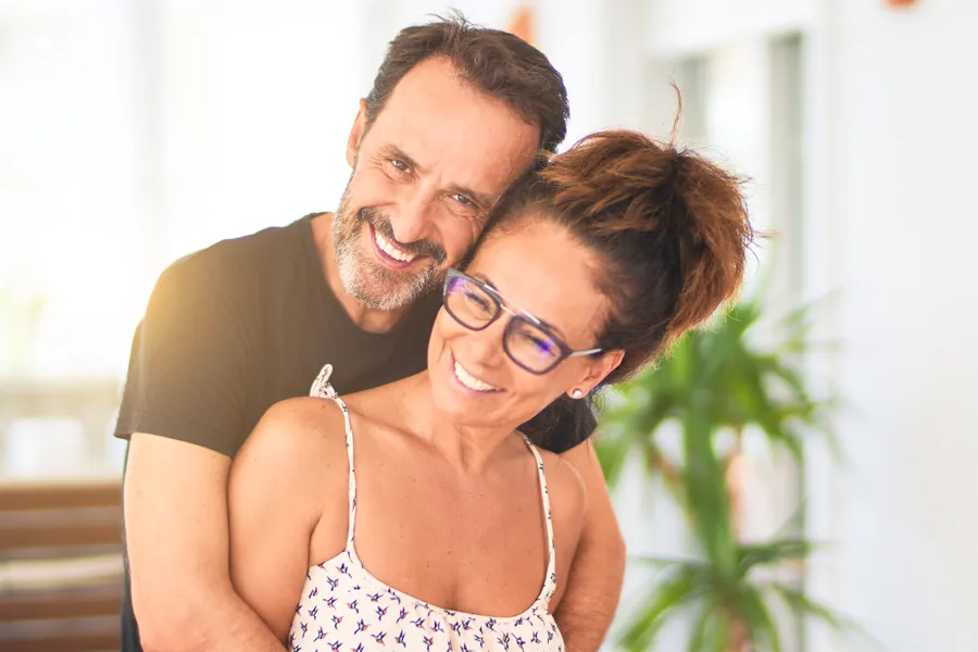 IV-Therapy-for-Fatigue-and-Energy-Clinic A middle-aged couple embrace while making breakfast. Get IV Therapy for Fatigue and Energy from Jennifer Jose-Cappola, MD in Stamford.