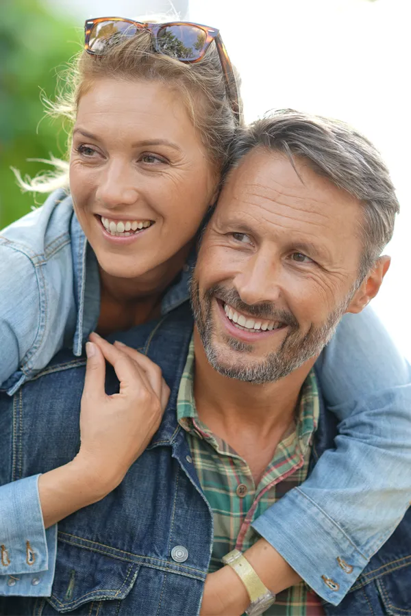 IV-Therapy-for-Fatigue-and-Energy-Treatment A middle-aged couple embrace while on vacation. Get IV Therapy for Fatigue and Energy from Jennifer Jose-Cappola, MD in Stamford.