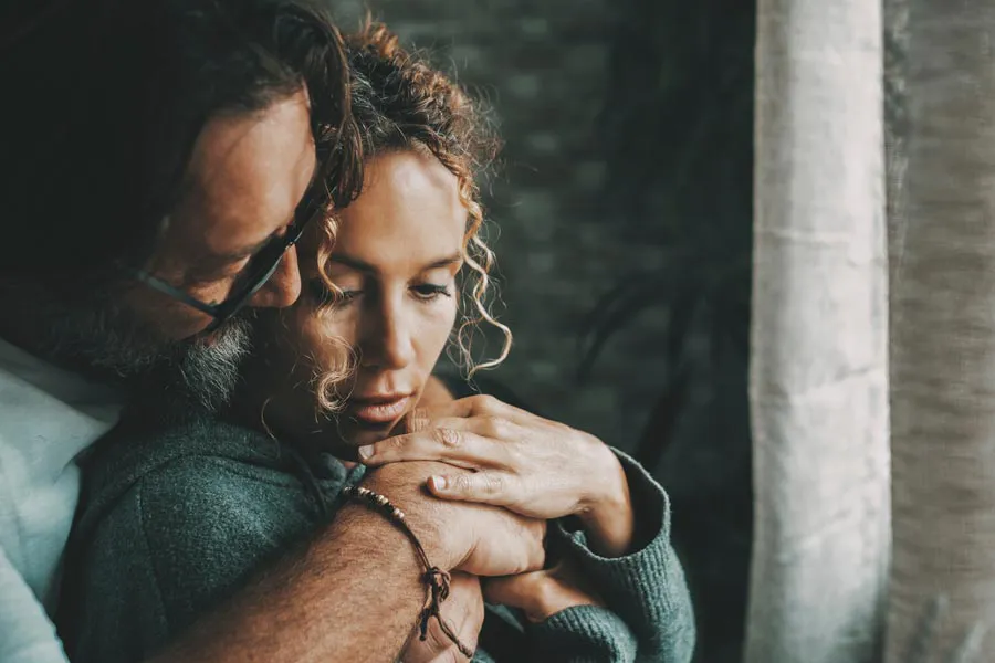 Mood-Imbalance-Therapy A husband comforts his melancholy wife. Get mood imbalance therapy from Jennifer Jose-Cappola, MD in Stamford.