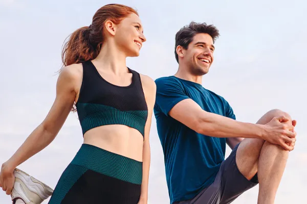 PRP-for-Sports-and-Orthopedics-Clinic A couple in exercise clothes stretching and preparing for a run. Get Platelet Rich Plasma (PRP) treatment for sports and orthopedics from Jennifer Jose-Cappola, MD in Stamford.
