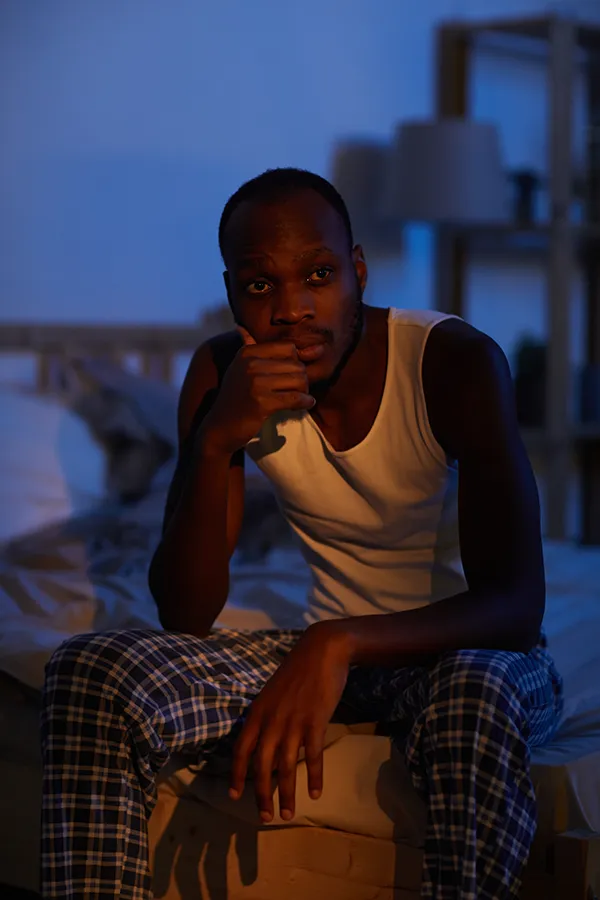 Sleep-Disorders-Treatment A man sits on the edge of his bed concerned that he can't sleep. Get treatment for sleep disorders from Jennifer Jose-Cappola, MD in Stamford.