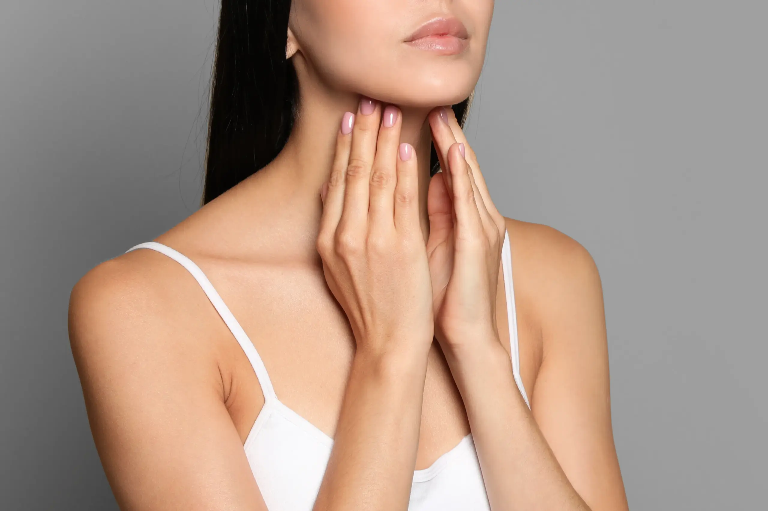 Thyroid-Doctor A woman in a white tank top touches her neck looking for signs of thyroid disorder. Get help for thyroid disorders from Jennifer Jose-Cappola, MD in Stamford.