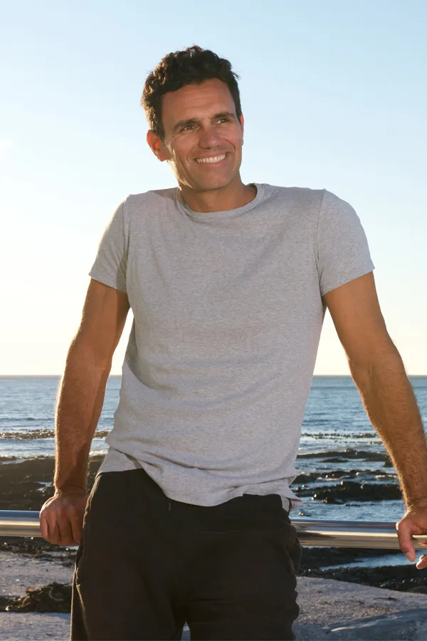 Vitality-Regenerative-Medicine-Treatment A happy, healthy man leans against a rail by the ocean. Get Vitality Regenerative Medicine treatment from Jennifer Jose-Cappola, MD in Stamford.
