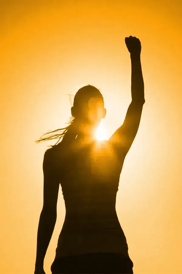 Vitamin-D3-Injection-Treatment A woman raises her hand in triumph in the sunlight. Get Vitamin D3 Injections from Jennifer Jose-Cappola, MD in Stamford.