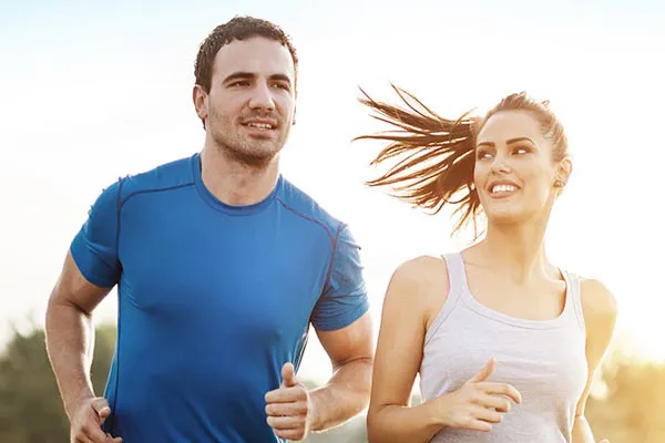 Weight-Loss-Resistance-Doctor A couple happily jogging in the sunlight after receiving effective weight loss resistance care from Jennifer Jose-Cappola, MD in Stamford.